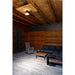 Outdoor patio with gray wicker chair, dark gray sofa, wood and metal tables, and ceiling-mounted bronze light fixture.