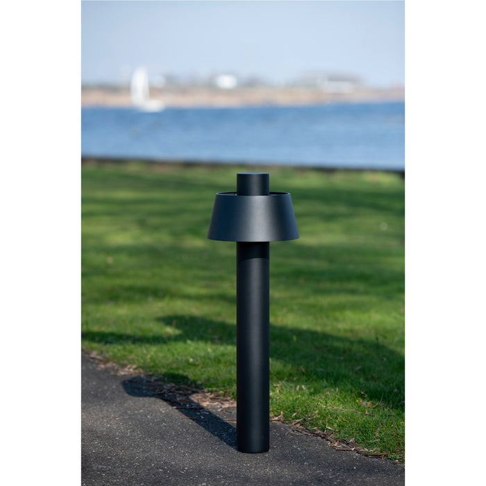 Black metal bollard light fixture with a matte finish, ground mounted.