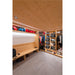 Wood closet with built-in bench, shelves, and hanging space for ski gear and clothing, with gray tile flooring.