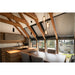 Modern kitchen with wood cabinets, gray countertops, wood table, gray chairs, and gray window blinds.