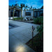 Black metal outdoor spotlight, ground mounted.