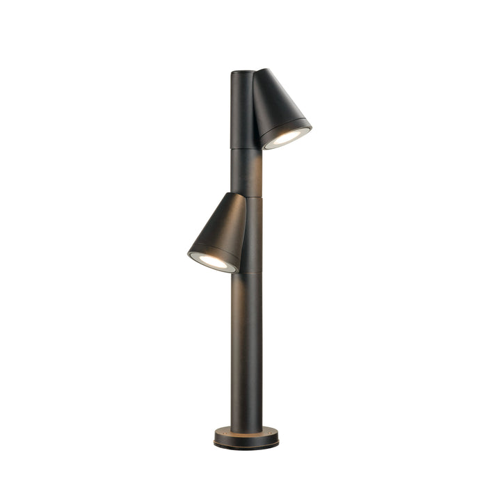 Modern bollard light fixture, dark bronze finish, ground mounted.