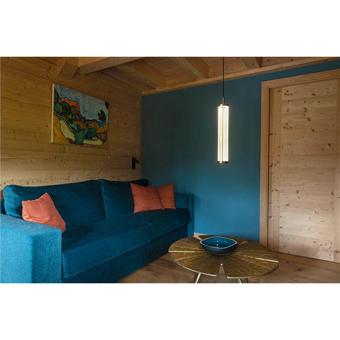 Hanging linear pendant light fixture with bronze accents in a modern living room.