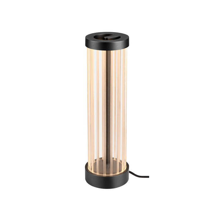 Black metal table lamp with cylindrical glass shade and vertical stripes.