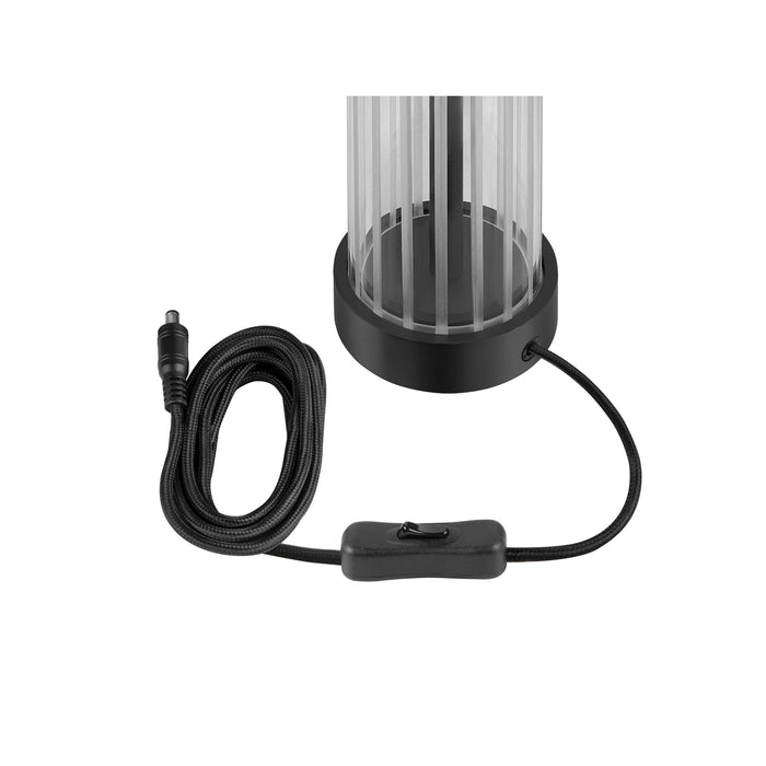 Black table lamp with clear acrylic shade and black fabric-covered cord.