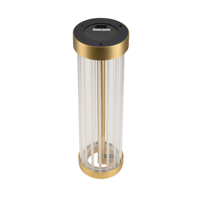 Table lamp with clear ribbed glass shade and gold finish metal base.