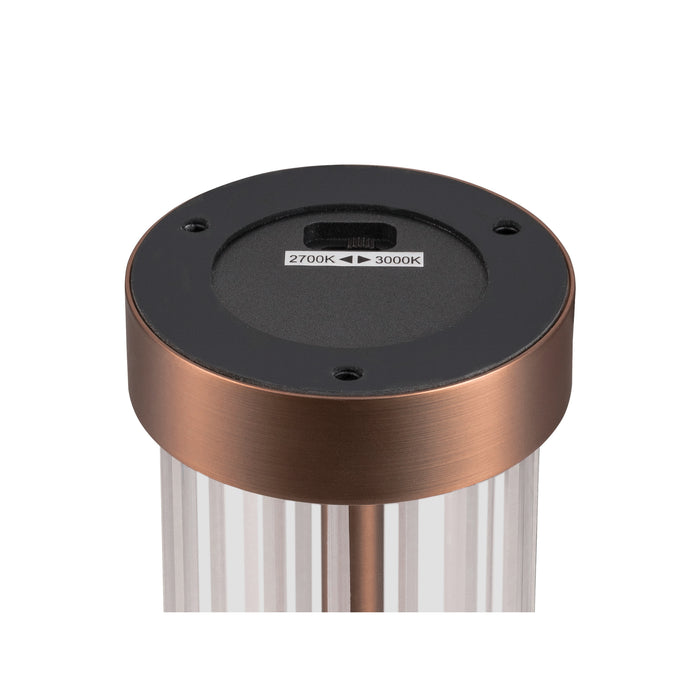 Close-up of a copper-finish metal outdoor light fixture with a 2700K-3000K color temperature switch on the black base.