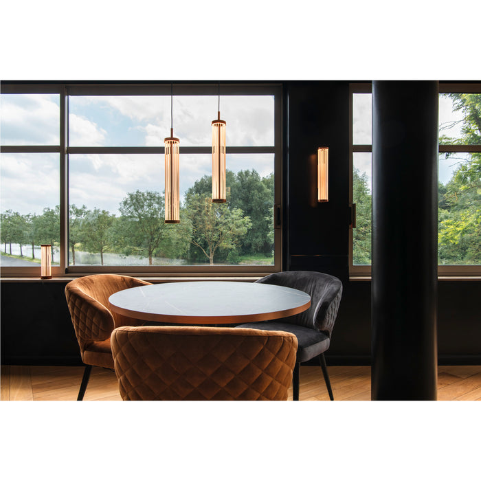 Modern ribbed glass pendant and wall sconce lighting in a dining area with round table and velvet chairs.