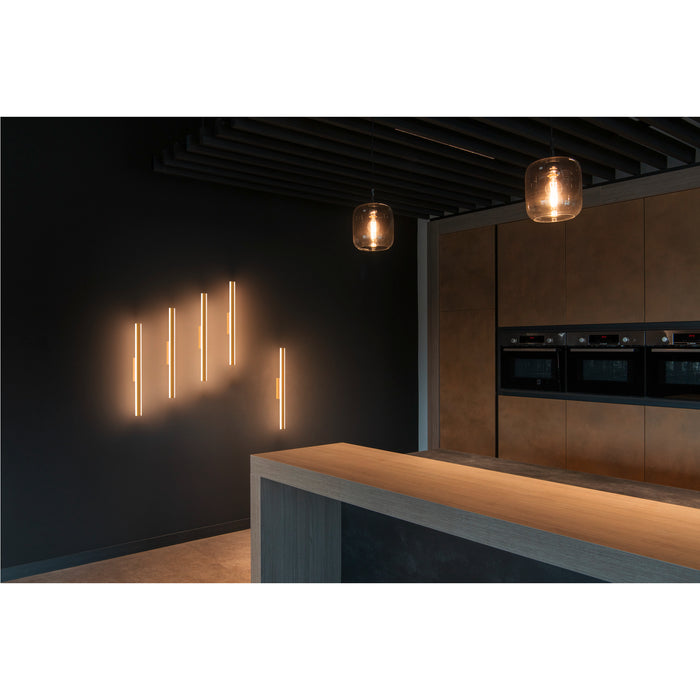 Modern kitchen with wall-mounted LED light bars and pendant lights.