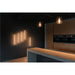 Modern kitchen with wall-mounted LED light bars and pendant lights.
