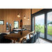 Interior with wood walls, glass-topped wood table, black velvet chairs, and pendant lights.