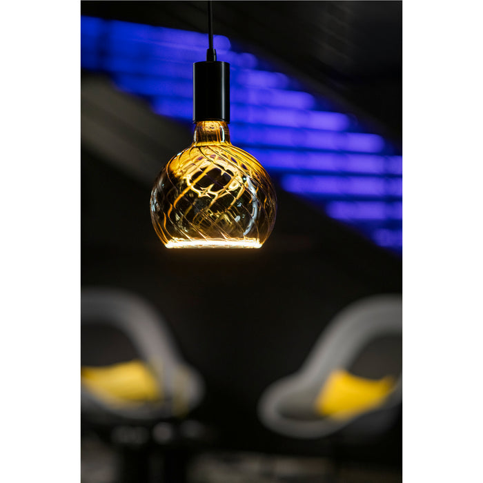 Hanging glass pendant light with amber finish and black mounting.