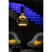 Clear glass pendant light fixture with black mount and warm yellow glow.