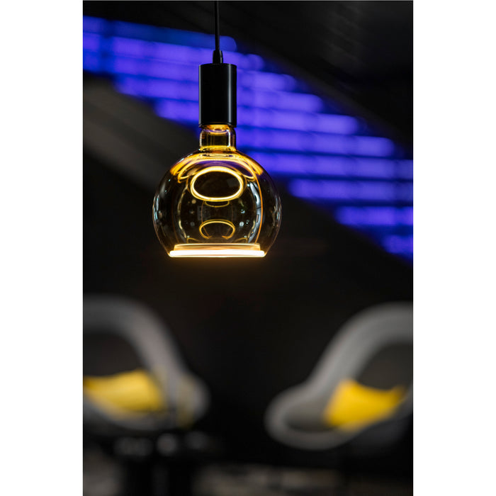 Hanging glass pendant light with black fixture and warm, glowing filament.