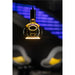 Hanging glass pendant light with black fixture and warm, glowing filament.