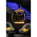 Pendant light with a smoked glass globe shade, black mounting, and warm-toned internal light element.