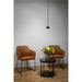 Black pendant light fixture, brown leather chairs, and black marble-top side table with flowers.