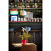 White pendant light fixture, suspended. Interior shot with plant in red pot on table.