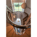 Spiral staircase with carpeted steps, stainless steel railing, and white pendant lights.