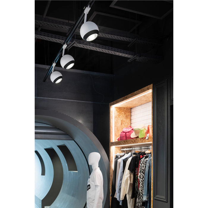 Modern track lighting with white globe shades and black trim, mounted on a black track in a retail space.