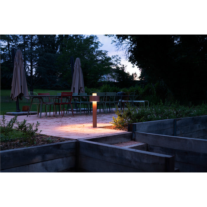 Bronze finish metal outdoor path light, ground mounted.