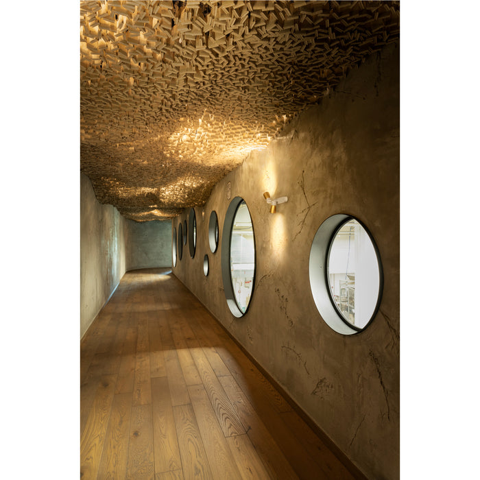 Hallway with wood floor, textured plaster walls, round windows, and wood slat ceiling.