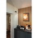 Modern kitchen detail with black cabinets, marble countertop, wood slat wall, and black track lighting.