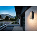 Modern black wall-mounted outdoor light fixture with horizontal slats.