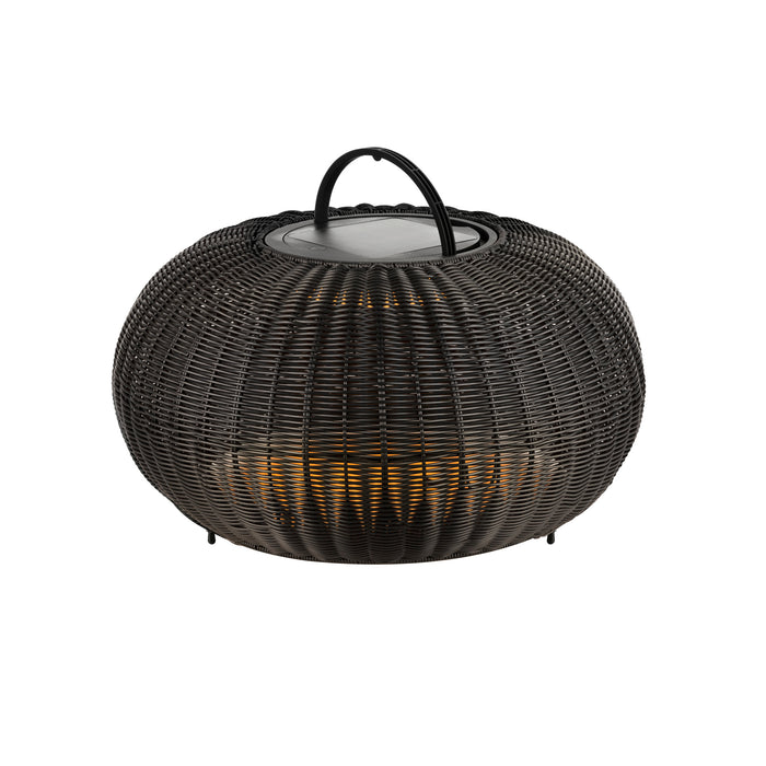 Black wicker lantern with handle, tabletop.