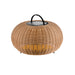 Wicker lantern with black handle, tan finish, and warm light, standing on small legs.