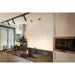 Modern kitchen with black track lighting, stainless steel range hood, black granite countertop, and light gray cabinets.