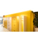 Built-in wood lockers, yellow and light wood finish, with keys, next to a yellow wall and plant.