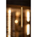 Modern gold cylinder pendant light fixture, metal with matte finish, suspended from ceiling.