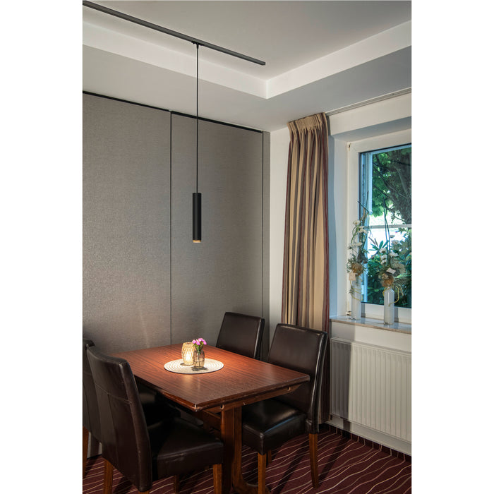 Black cylinder pendant light fixture mounted on track lighting above dining table.