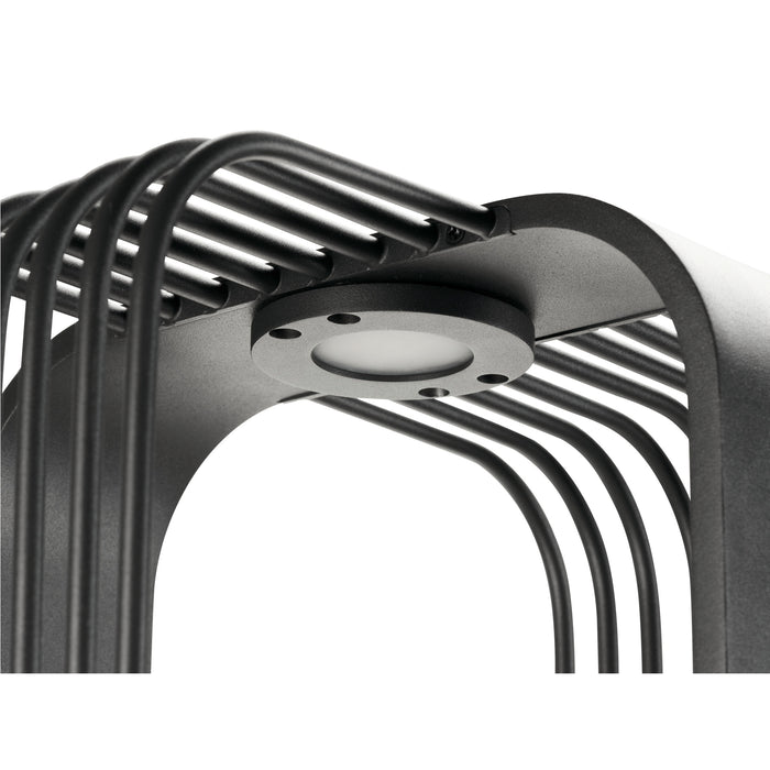 Close-up of a black metal outdoor light fixture with a textured finish and integrated LED, surface mounted.