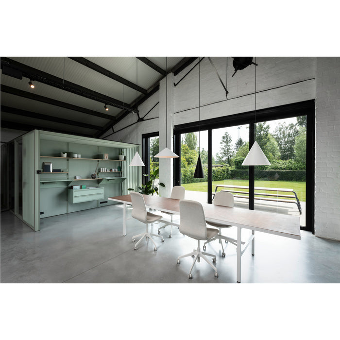 Modern office interior with light wood table, white metal frame, light gray chairs, and sage green storage unit.