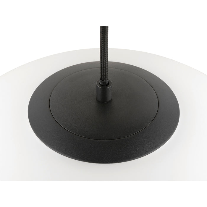 Close-up of a white glass pendant light with a black metal canopy and a black fabric cord.