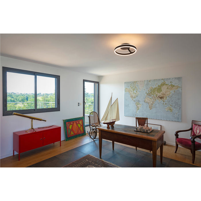 Modern office interior with black ring LED ceiling light.
