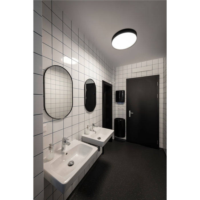 Modern bathroom with white tiled walls, black door and floor, and two white ceramic sinks with chrome faucets.