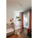 White track lighting fixture with three adjustable spotlights, ceiling mounted in a child's bedroom.