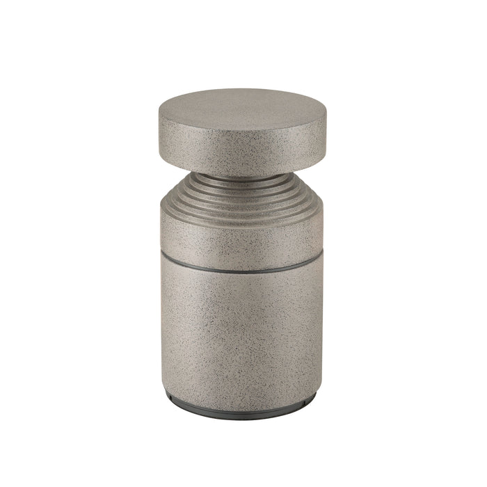 Gray concrete bollard with speckled finish.