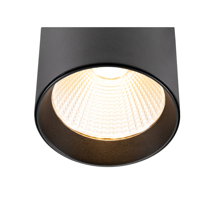 Black cylinder surface-mounted light fixture with textured finish.