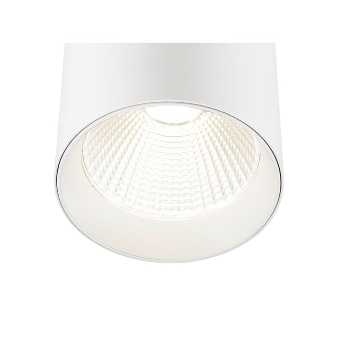 White cylinder surface-mounted light fixture with textured reflector.