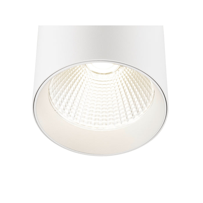 White cylinder surface-mounted light fixture with textured reflector.