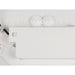 Close-up of a white LED light fixture showing the color temperature switch (3000K/4000K) and knockouts.
