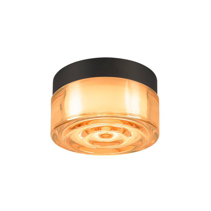 Amber glass flush mount ceiling light fixture with black trim.