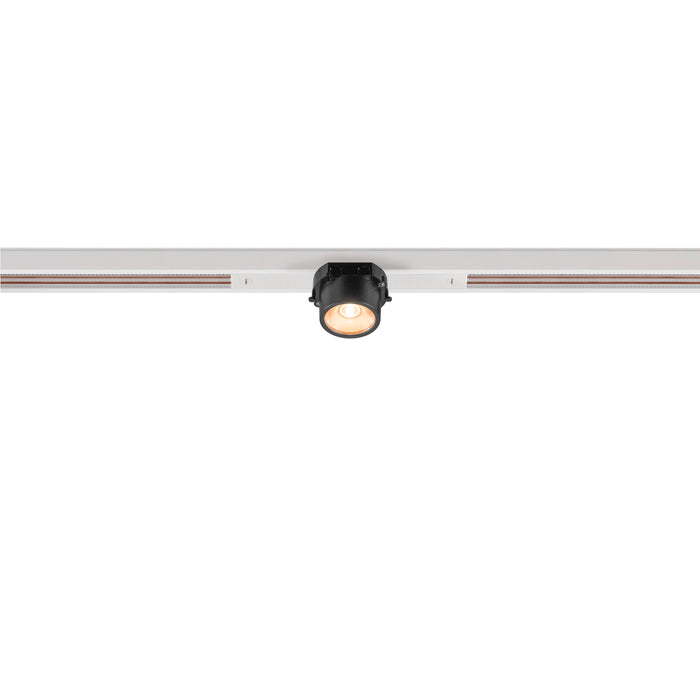 Black track lighting fixture mounted on a white track.