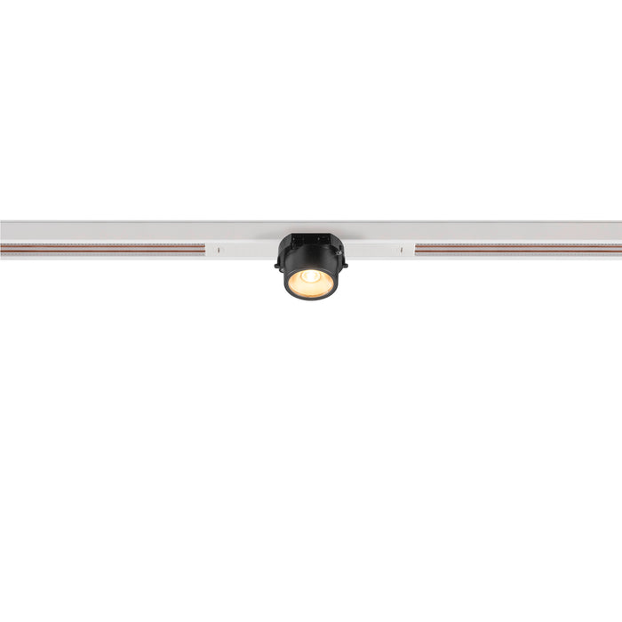 Black track lighting fixture mounted on a white track.