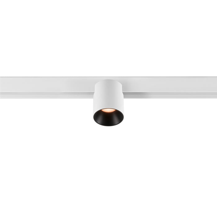 White cylinder track lighting fixture.