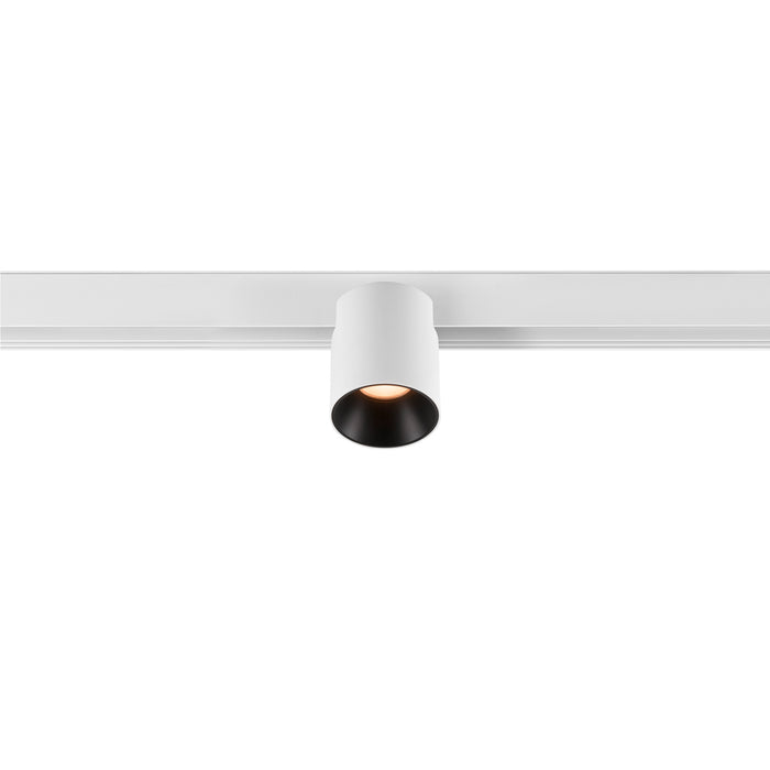 White cylinder track lighting fixture.